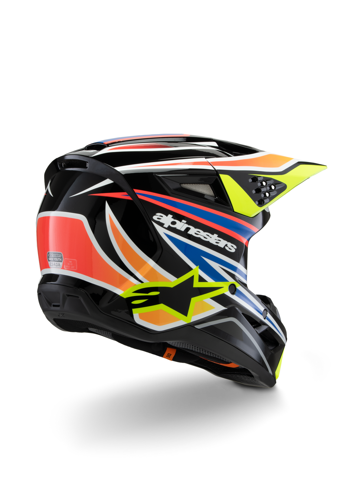 Casque Alpinestars S-M3 Youth Wurx, casque de motocross pour enfant, noir avec accents orange vif, rouge, bleu et jaune fluo, vue de trois-quarts arrière montrant la coque aérodynamique et les orifices de ventilation, finition brillante avec logo Alpinestars bien visible.