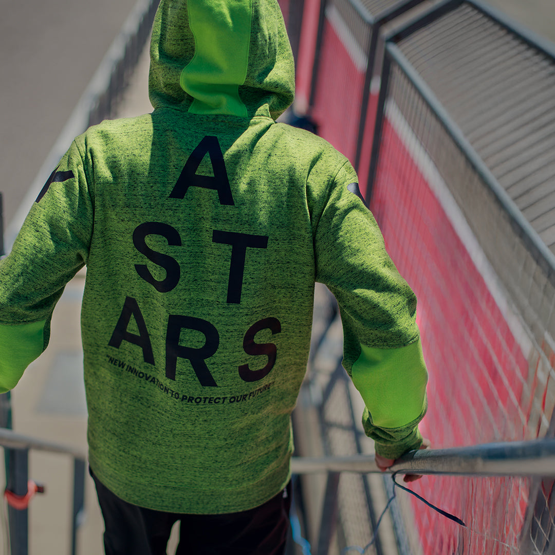 Sweat à capuche Alpinestars Perpetuate, vue de dos, molleton chiné vert lime, grand graphique ASTARS noir au dos, vêtement sportswear décontracté avec blocs de tissu et capuche à cordon de serrage
