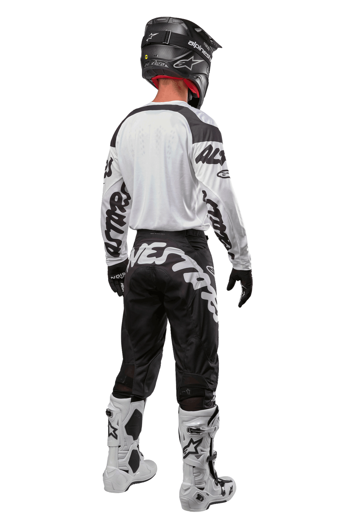 Alpinestars 2024 Racer Hana Hose, Motocross-Hose, Schwarz und Weiß mit markantem Logo-Schriftzug am Gesäß, Rückansicht der kompletten MX-Ausrüstung inklusive weißem Trikot und Stiefeln