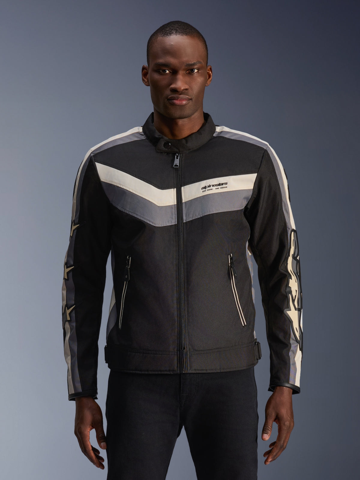 Alpinestars T-Dyno WR Jas, textiele motorjas, zwart, donkergrijs en ecru, met chevron-streeppatronen op de borst en mouwen, vintage-geïnspireerde biker-pasvorm met opstaande kraag, urban eigentijdse motorkleding