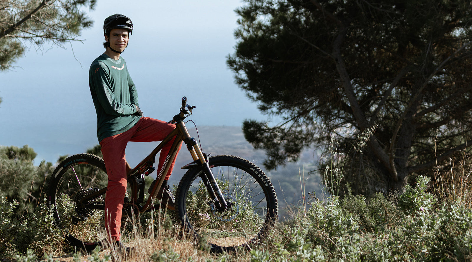 MTB rider sitting on his bike in a natural environment, wearing Alpinestars A-Dura clothing.