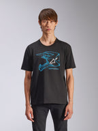 Alpinestars CSF Tee, t-shirt à manches courtes noir, graphisme de casque de motocross bleu avec logo Astars blanc, streetwear décontracté d'inspiration sport automobile porté par un mannequin