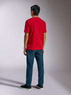 Alpinestars Ageless Shadow CSF Tee, T-shirt met korte mouwen, rood, achteraanzicht gedragen door een model met blauwe jeans en zwarte sneakers, casual motorsport streetwear