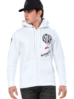 Alpinestars Variegate Hoodie, White Zip-Up Hoodie with black and red ASTARS racing graphics, worn by a model with a black cap and dark jeans, casual motorsport streetwear featuring a kangaroo pocket and drawstring hood