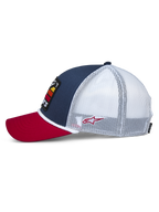 Alpinestars Selica Trucker pet, zijaanzicht, rode gebogen klep, marineblauw voorpaneel met witte mesh achterzijde, witte gevlochten koordafwerking, klein rood geborduurd logo, casual motorsport-geïnspireerde stijl