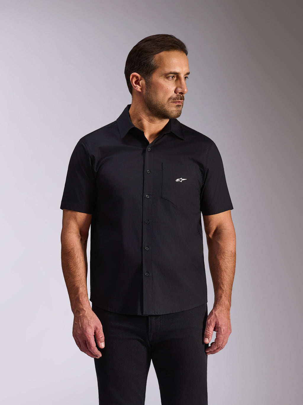 Alpinestars Strive Woven Shirt, overhemd met korte mouwen en knoopsluiting, zwart, wit Alpinestars-logo op de borstzak, casual motorsport streetwear