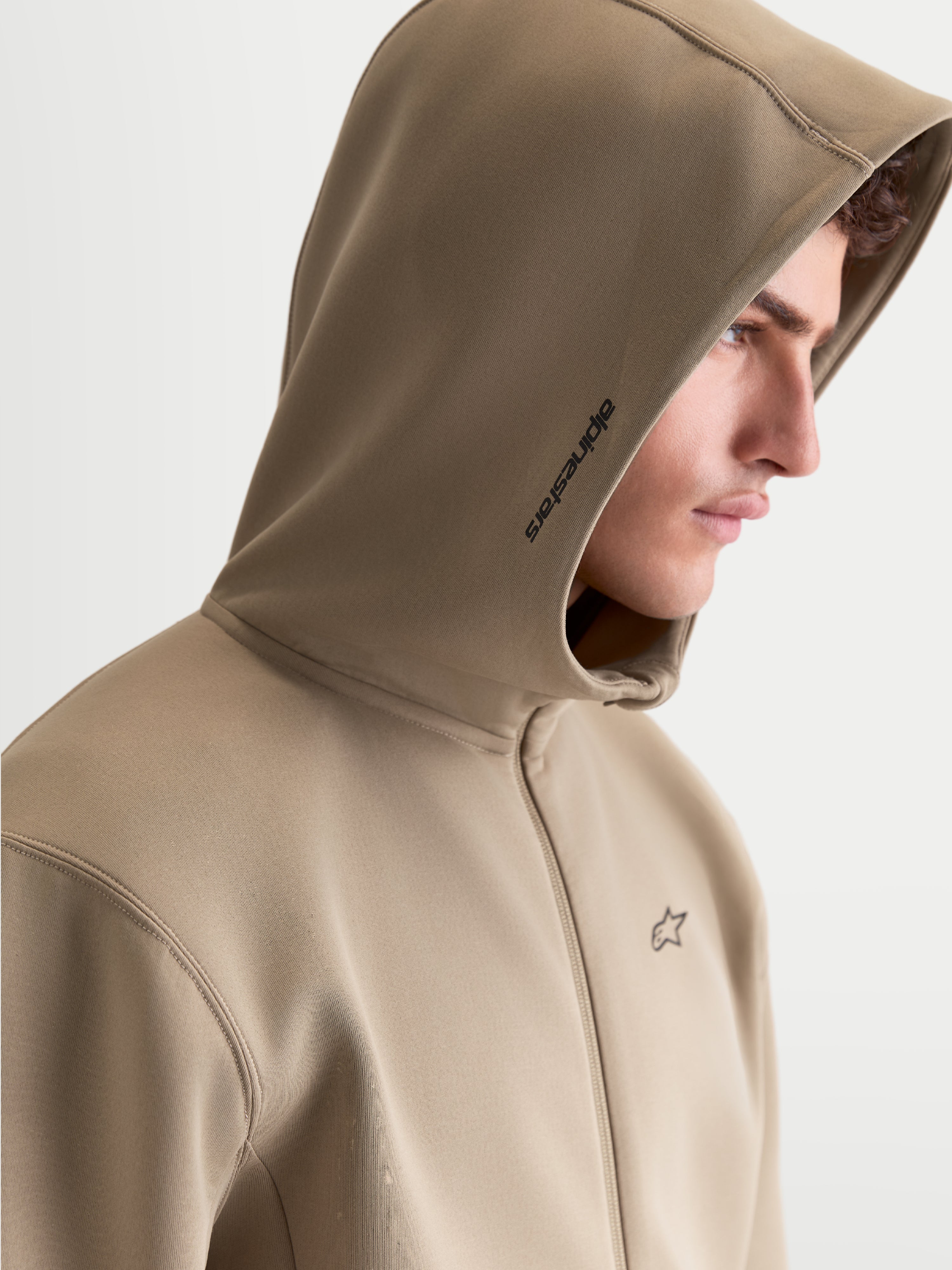 Alpinestars Cypher Hoodie, Sportswear Zip-Front Fleece, Men, Putty Beige, featuring a high-neck mesh-lined hood with side Alpinestars branding and chest logo, on-model profile view.