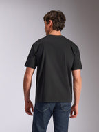 Alpinestars Aplomb Oversized CSF Tee, T-shirt met korte mouwen, zwart, achteraanzicht, gedragen door model met blauwe jeans, relaxed fit casual sportkleding