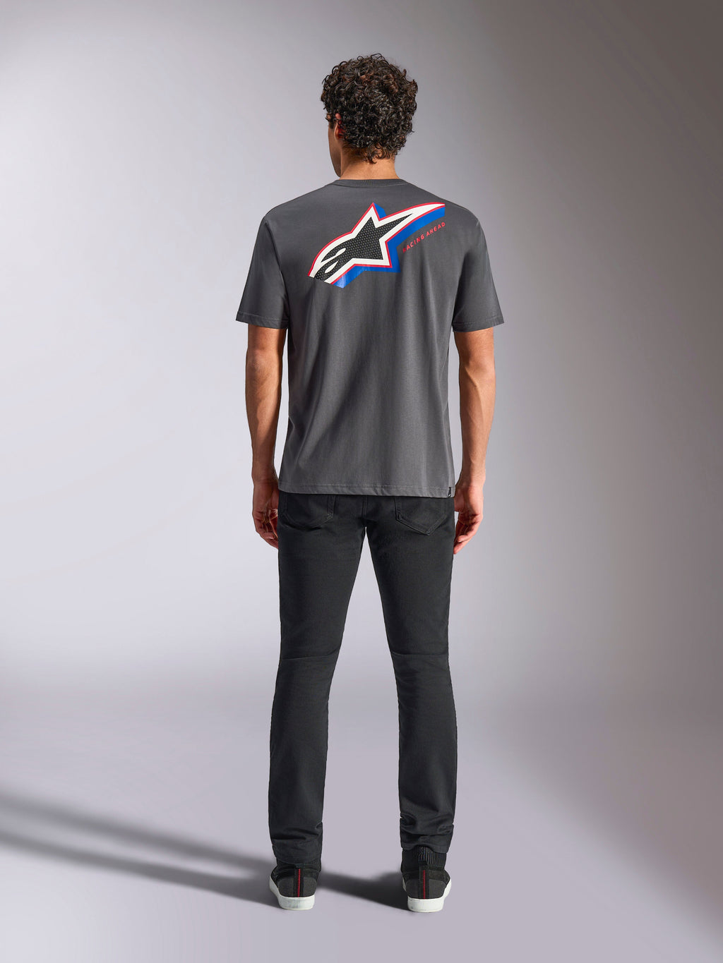 Alpinestars Angler CSF Tee, Short Sleeve T-Shirt, Charcoal, Large Multi-color Astars Logo on back with red and blue accents, rear view on model, casual motorsport streetwear