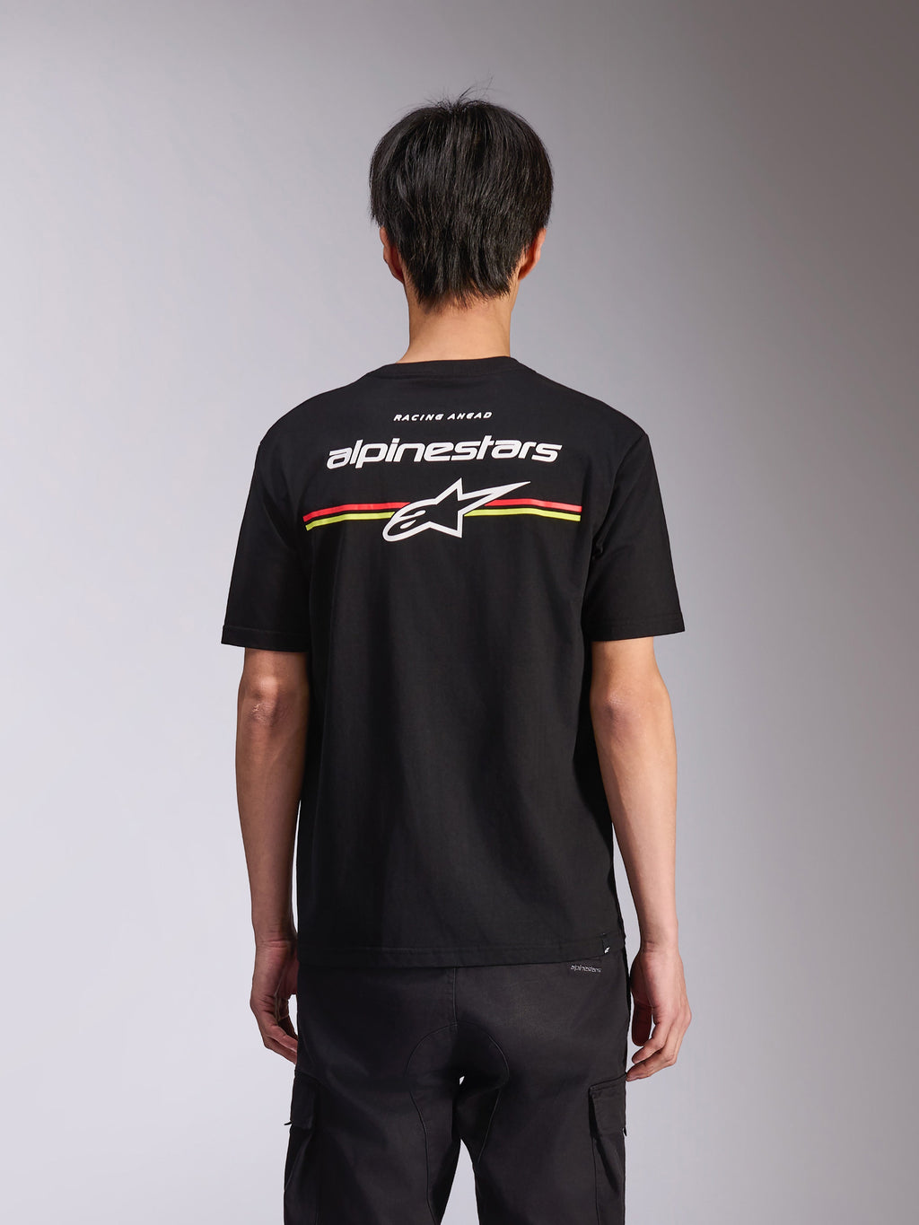 Alpinestars Lanes CSF Tee, T-shirt met korte mouwen, zwart, achteraanzicht met wit Alpinestars-logo en Astars-ster met rode en gele strepen, casual motorsport streetwear