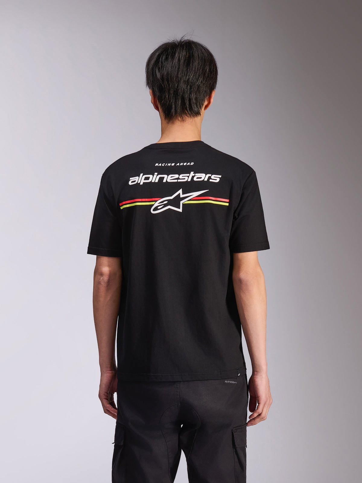 Alpinestars Lanes CSF Tee, T-shirt met korte mouwen, zwart, achteraanzicht met wit Alpinestars-logo en Astars-ster met rode en gele strepen, casual motorsport streetwear