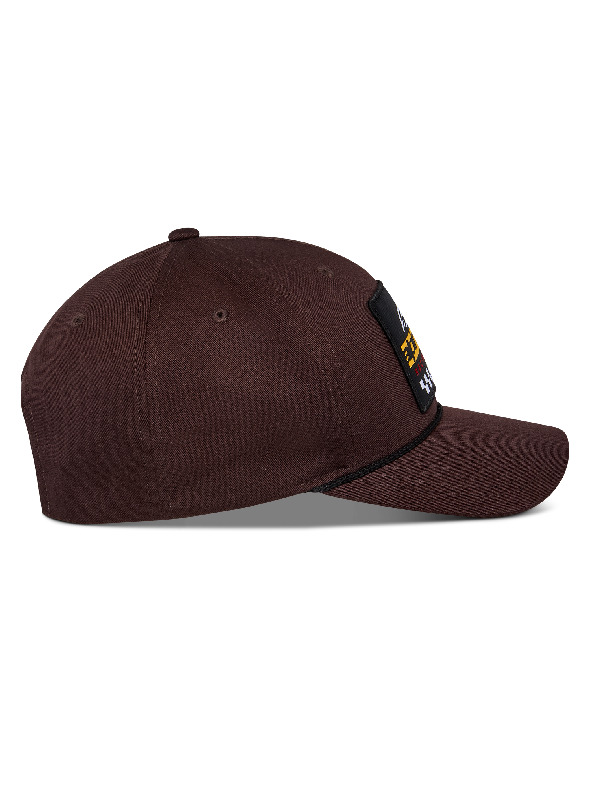 Alpinestars Matrix Snapback pet, donkerbruin, zijaanzicht met gebogen klep, gestructureerde kroon en logopatch aan de voorzijde met touwdetail, casual motorsport-geïnspireerde hoofdbedekking