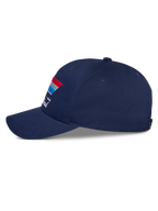 Alpinestars Trifecta Snapback pet, marineblauw, zijaanzicht, voorzien van gebogen klep en driekleurige streepgrafiek met witte tekst, casual motorsport-hoofddeksel