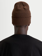 Alpinestars Augment Cuff Beanie, sportswear knit beanie, brown, rear view showing deep-fit silhouette worn by a model