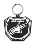 Alpinestars Plate sleutelhanger, 3D-gevormde sleutelhanger, zwart en wit, voorzien van Astars MX-plaatgrafiek met wit logo en tekst, zilverkleurige metalen ring, motorsport-geïnspireerd accessoire