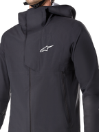 Veste imperméable Alpinestars A-Dura Elite, veste de cyclisme VTT, noire, dotée d'une membrane imperméable à 3 couches, d'une capuche par-dessus le casque, de poches zippées et d'une texture ripstop technique pour la pratique du VTT sur sentiers