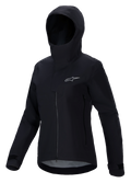 Veste imperméable Alpinestars Stella A-Dura Elite, veste de VTT pour femme, noire, avec design à capuche et rabat de protection, fermeture éclair frontale, poches zippées et poignets réglables par velcro, tissu technique imperméable avec logo argenté sur la poitrine