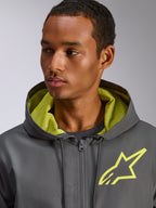 Alpinestars Speeder Chromium Windbreak Jas, antracietgrijs met Hi-Vis gele accenten, voorzien van een geel sterlogo op de borst en bijpassende mesh voering in de capuchon, lichtgewicht casual windbreaker