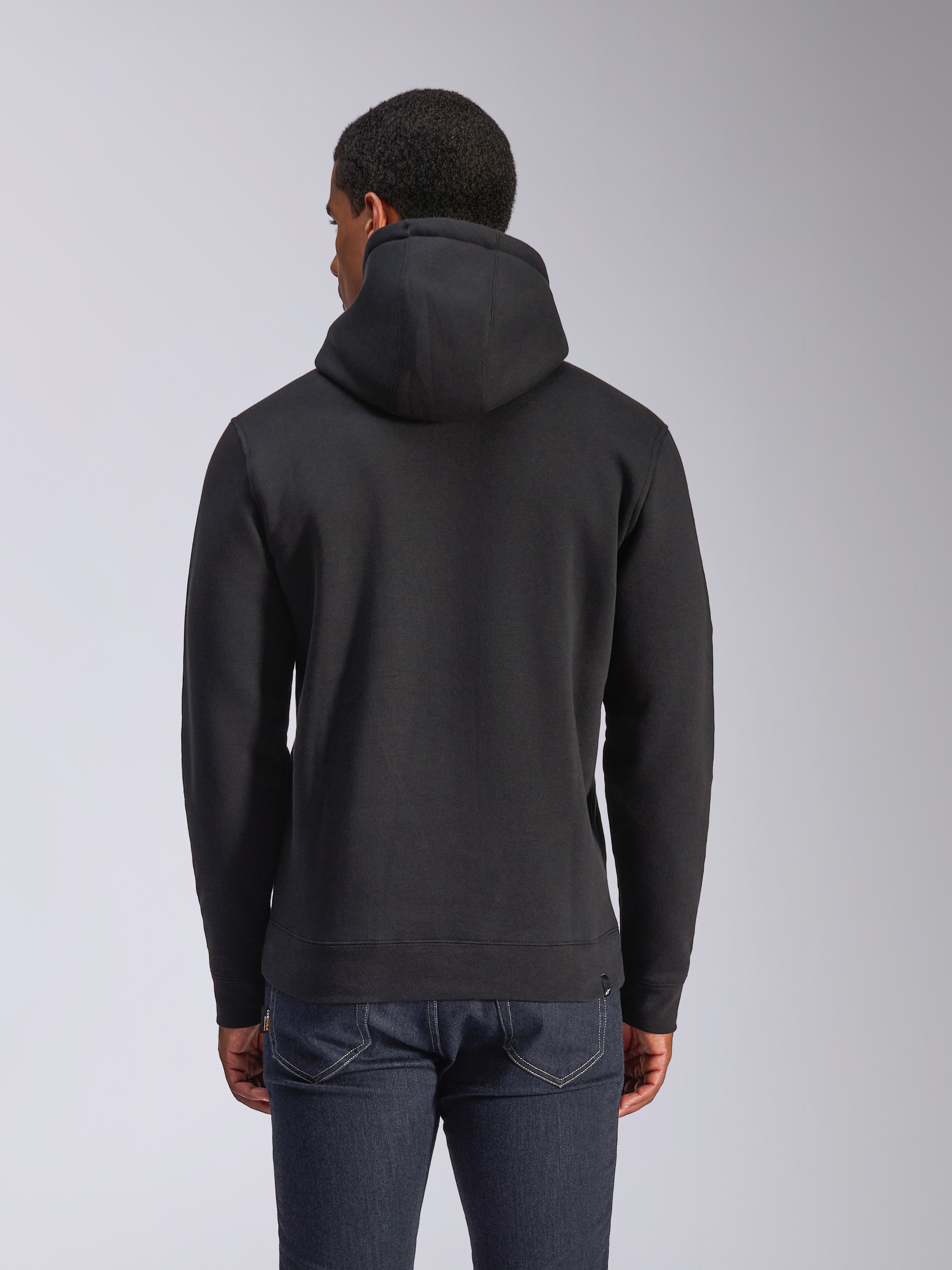 Alpinestars Blaze V3 Hoodie, rear view of black pullover fleece hoodie, casual streetwear, featuring ribbed cuffs and hem, jersey-lined hood, worn with dark blue jeans