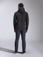 Alpinestars Blaze V3 Hoodie, casual streetwear, black, back view of hooded fleece sweatshirt, worn with dark blue denim jeans and black shoes, clean motorsport-inspired design