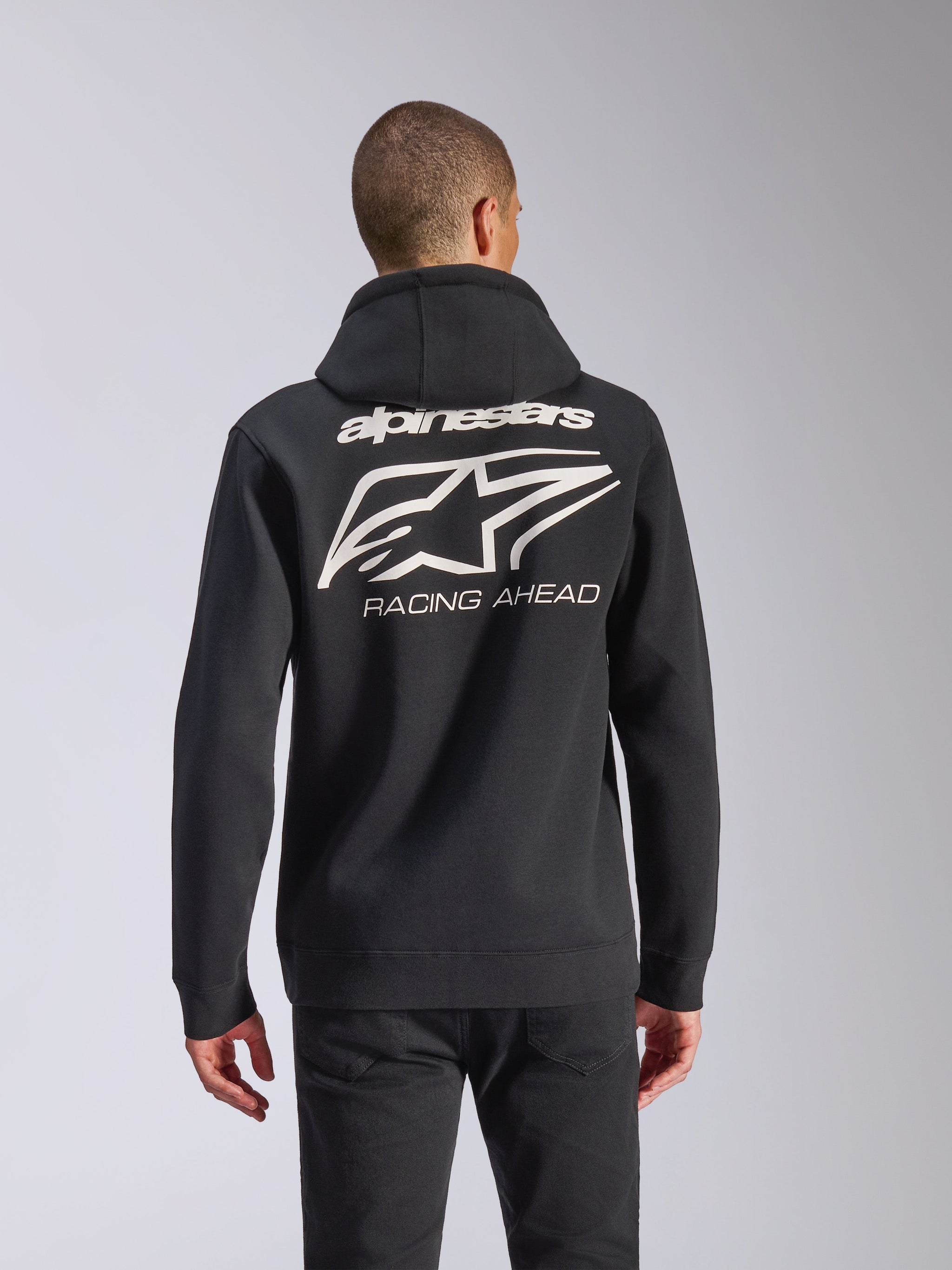 Alpinestars Formulation Hoodie, schwarzer Zip-Hoodie, Rückansicht mit großem cremefarbenem Alpinestars-Stern-Logo und „RACING AHEAD“-Schriftzug, lässige, vom Motorsport inspirierte Streetwear