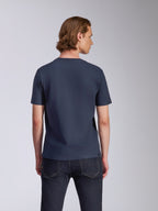 Alpinestars Fasting CSF Tee, t-shirt à manches courtes, bleu marine, vue de dos, porté par un mannequin avec un jean foncé, streetwear décontracté inspiré du sport automobile