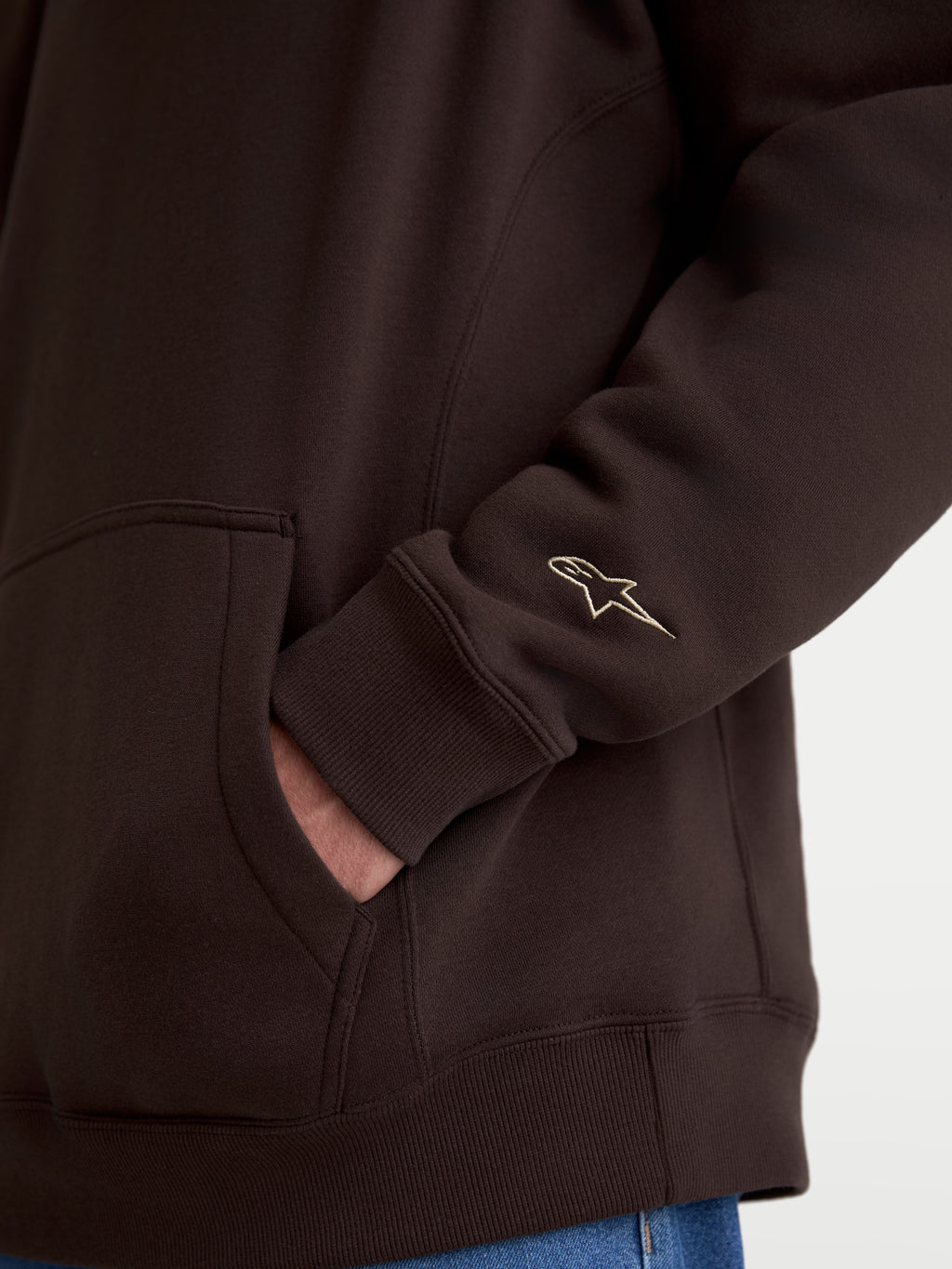 Alpinestars Guise Oversized Crew, Brown Sportswear Fleece Pullover, detail shot of embroidered Astars logo on sleeve and kangaroo pocket, oversized fit lifestyle apparel.