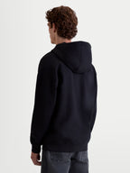 Alpinestars Sweat À Capuche Prelude Oversized, sweat à capuche sportswear décontracté, noir, vue de dos montrant la coupe ample, la capuche doublée et les finitions côtelées aux poignets et à l'ourlet.