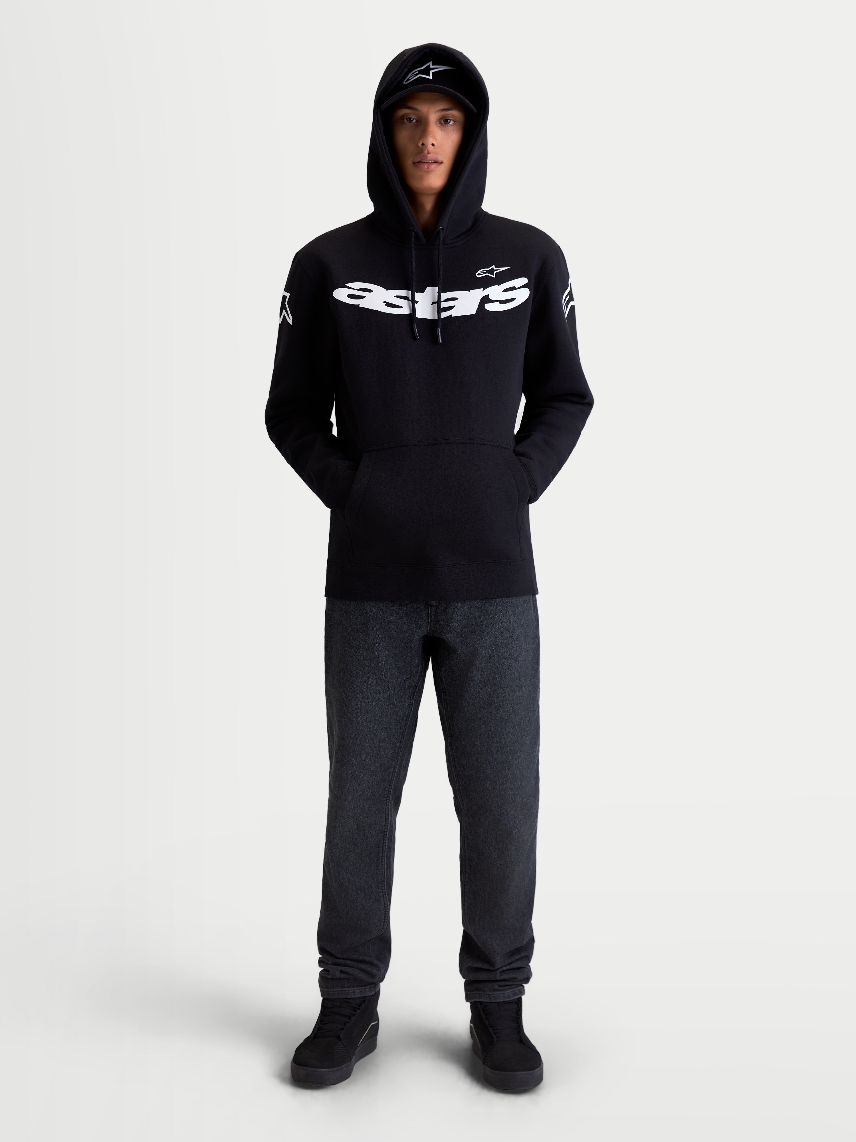 Alpinestars Sweat À Capuche Velocifier, sweat à capuche de sportswear, noir et blanc, mélange de coton et polyester recyclé, avec logo Astars sur la poitrine et logos sur les épaules, vu de face sur modèle pour un style décontracté hors moto