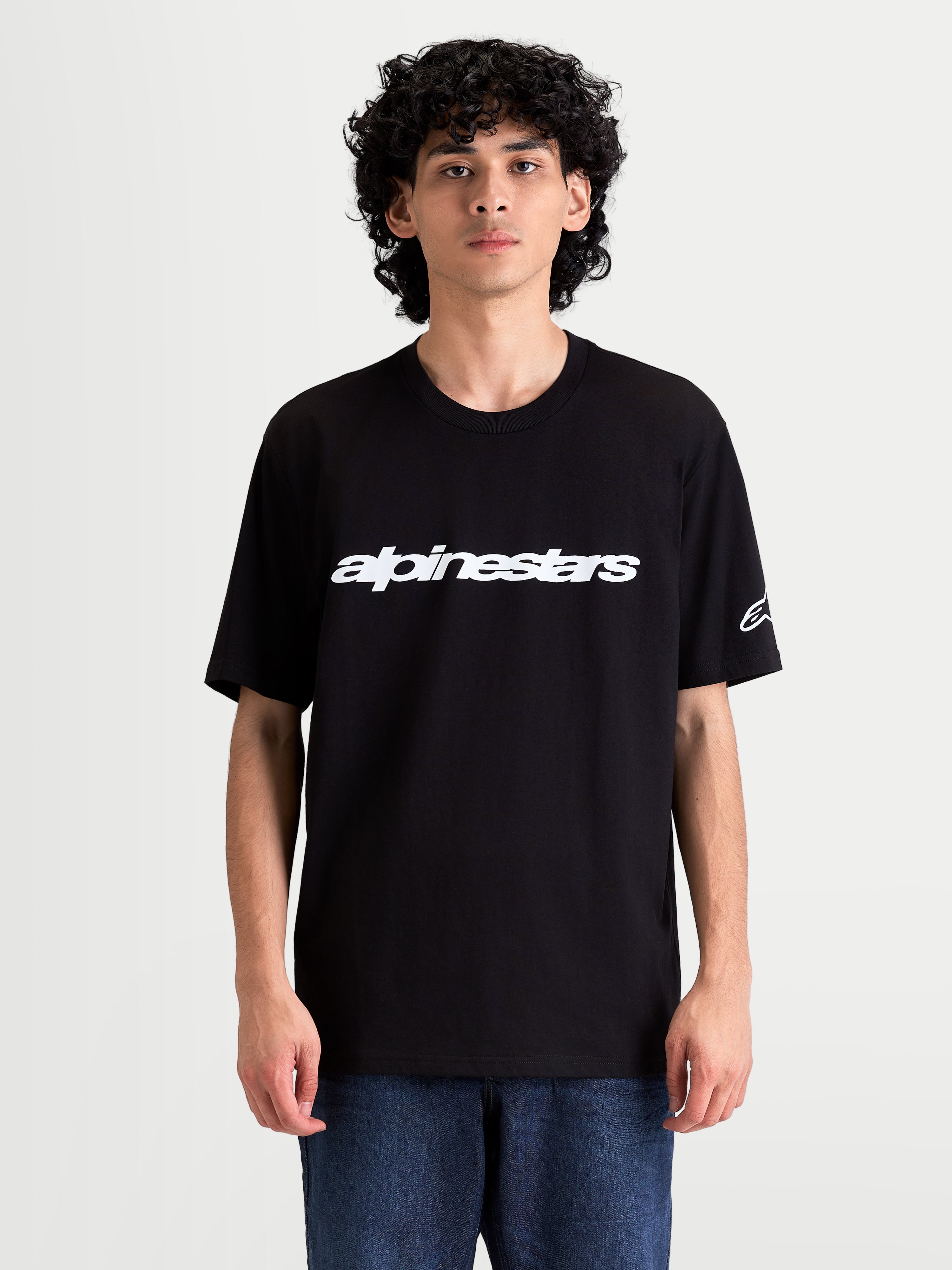 Alpinestars Race Wordmark CSF Tee, Men's Casual Sportswear Short Sleeve T-shirt on model, Black and White, featuring a bold front logo graphic and sleeve Ageless logo.