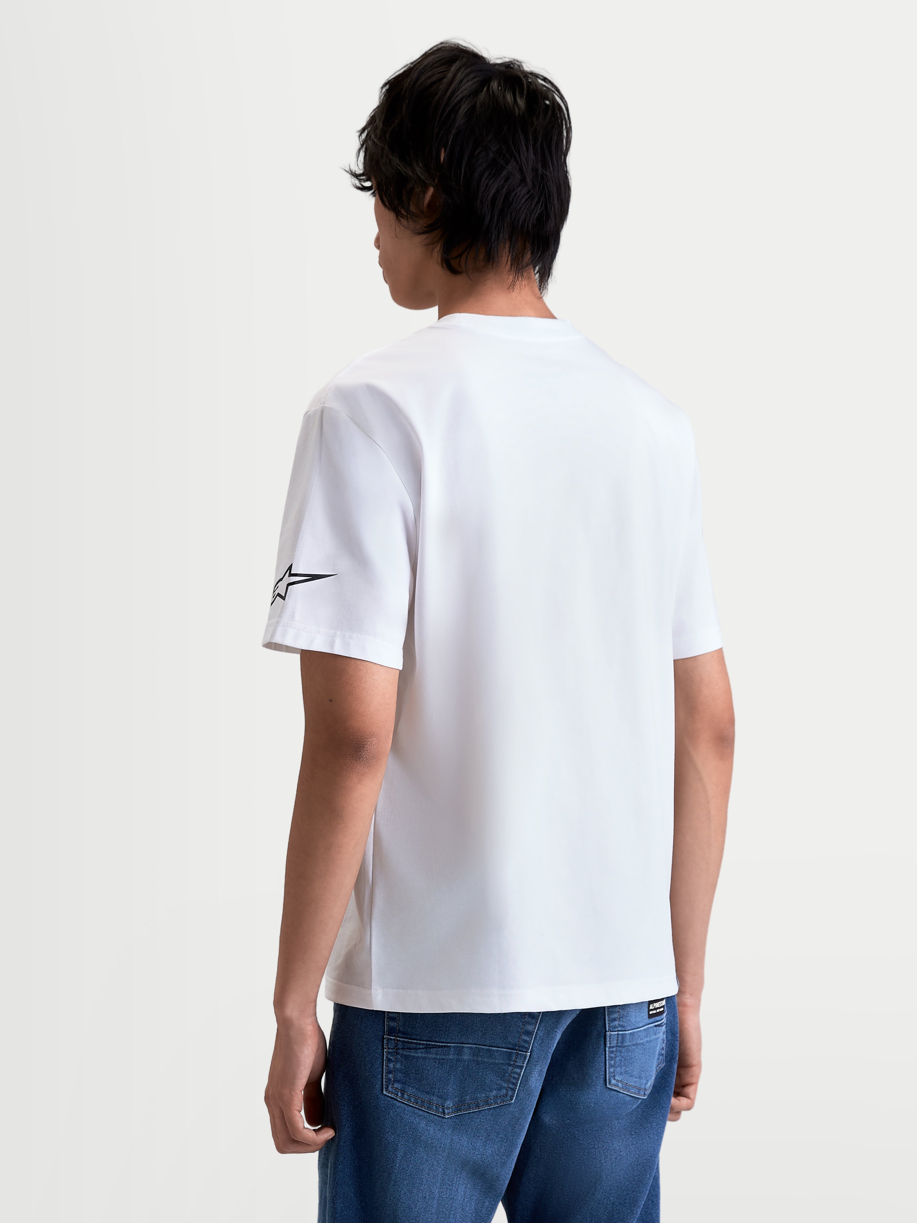 Alpinestars T-shirt Race Wordmark CSF, t-shirt de sportswear à manches courtes, unisexe, blanc et noir, vue de dos sur modèle montrant le logo Ageless sur la manche, mélange de coton et polyester.