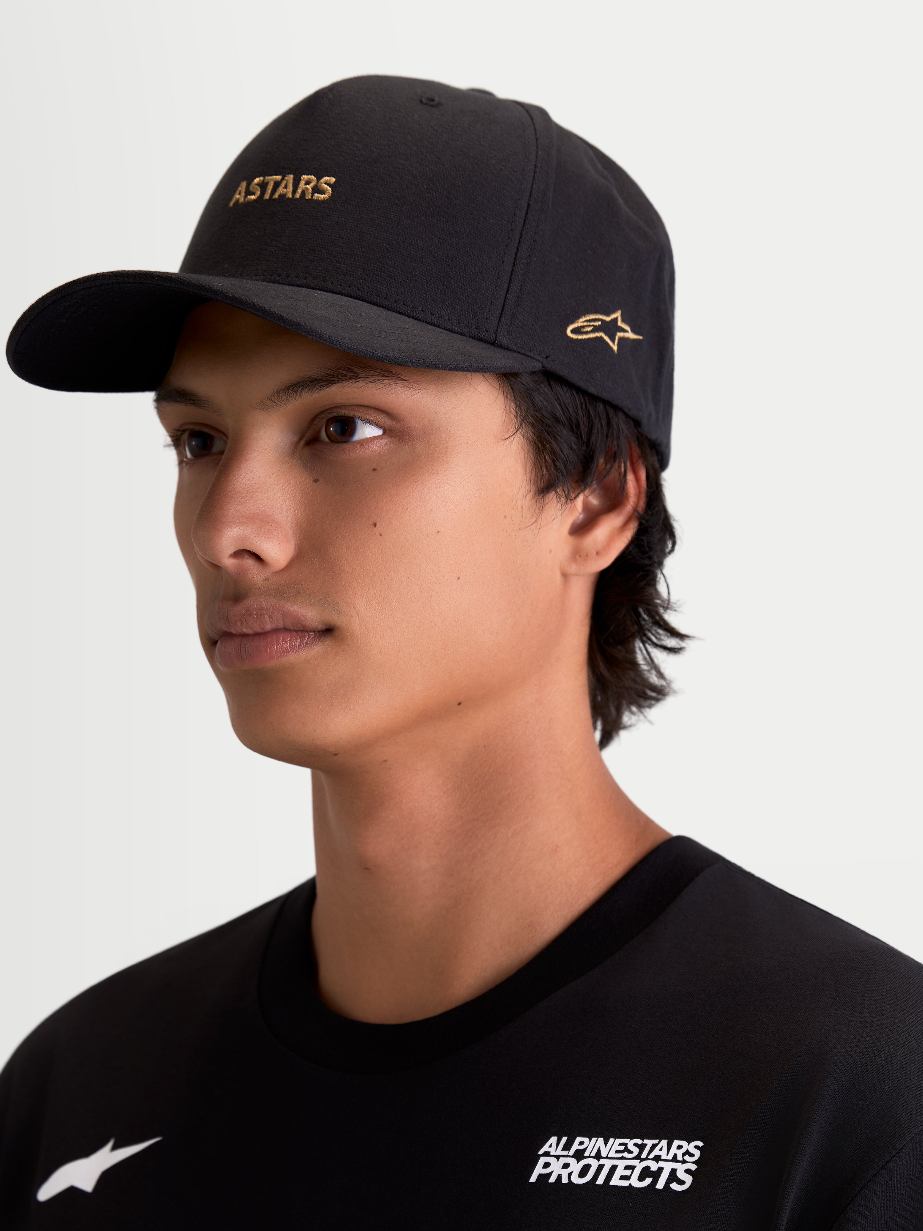 Alpinestars Casquette County Canvas, casquette de sportswear pour homme, noire et dorée, avec logo ASTARS écrit et broderie sur le côté, visière incurvée et couronne structurée, en tissu oxford au toucher peau de pêche