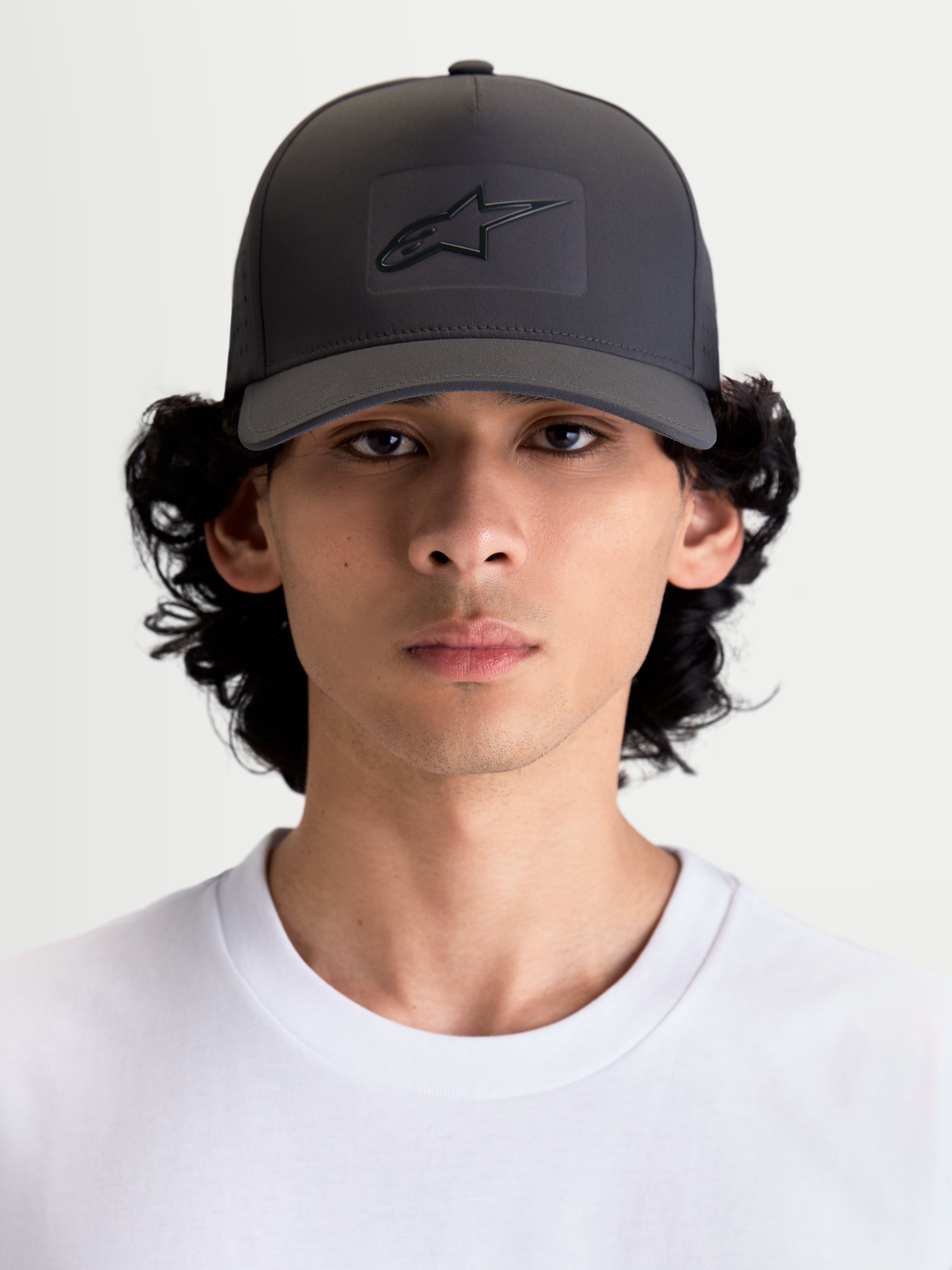 Alpinestars Algo Perf Adjustable Hat, Sportswear Snapback Cap for Men and Women, Dark Grey, featuring a structured crown, curved bill, and sonic-weld Astars logo heat stamp on technical fabric, on-model front view.