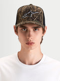 Alpinestars Thicket Realtree Trucker Hat, sportswear snapback cap in camo and black, worn by a model showcasing the structured crown and embroidered Astars logo on the front panel.