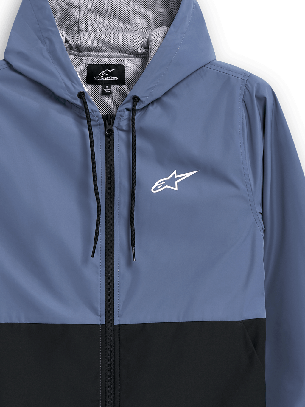Veste coupe-vent Alpinestars Speeder, bleu ardoise et noir, coupe-vent léger à capuche, doublure en mesh avec cordons de serrage noirs, logo Alpinestars blanc sur la poitrine, design bicolore par blocs, streetwear décontracté d'inspiration sports mécaniques