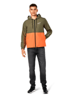 Alpinestars Speeder Windbreaker Jacket, color-blocked Military Green and Orange, lightweight hooded jacket with black drawcords and front zipper, white logo on chest and sleeve, worn with dark jeans and black sneakers, casual sportswear style.
