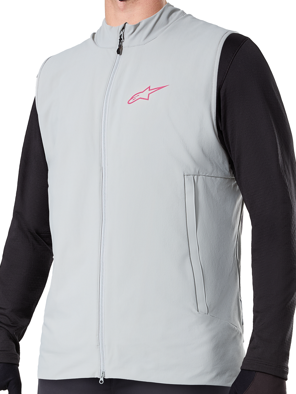 Gilet thermique Alpinestars A-Dura, gilet de cyclisme isolant gris titane, avec un logo étoile rose sur la poitrine, porté sur un haut noir à manches longues, comprend une poche zippée verticale et une fermeture éclair frontale, conçu pour le VTT par temps froid.