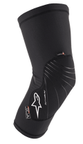 Alpinestars Paragon Lite Knee Protector, noire, équipement de protection léger avec construction en mesh texturé, logo blanc, lignes de design grises, conception à enfiler, avec étiquettes CE Niveau 1 et Polygiene, conçue pour le VTT et le cyclisme tout-terrain