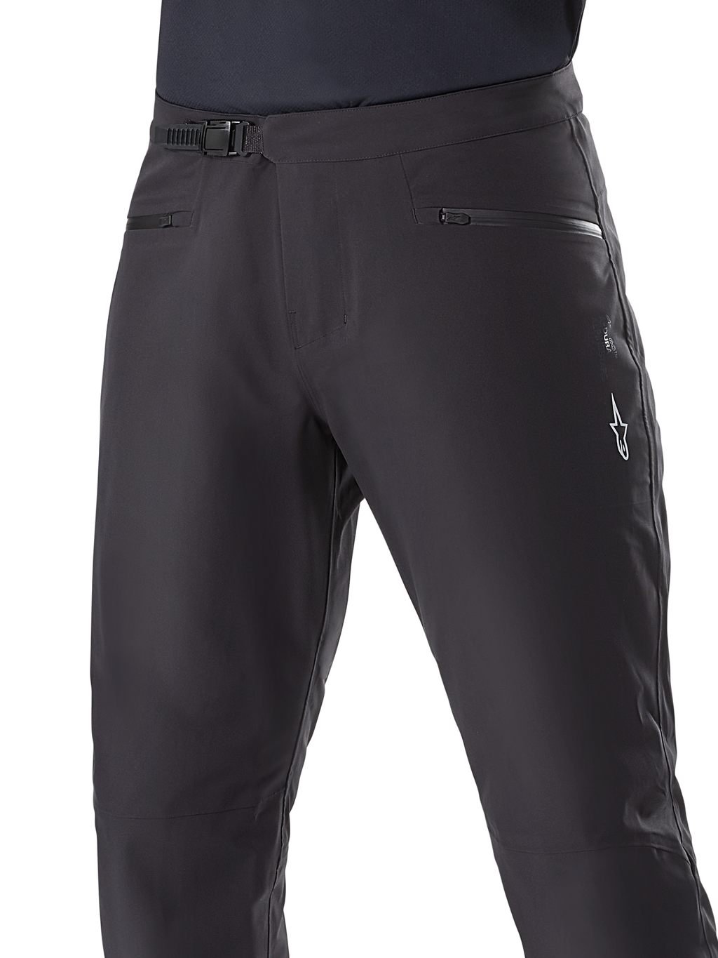 Alpinestars A-Dura Waterproof Pants, pantalon de VTT, noir, gros plan de la taille montrant le système de fermeture à cliquet et les poches zippées, logo Alpinestars blanc sur la cuisse, textile durable pour la pratique du VTT par temps humide