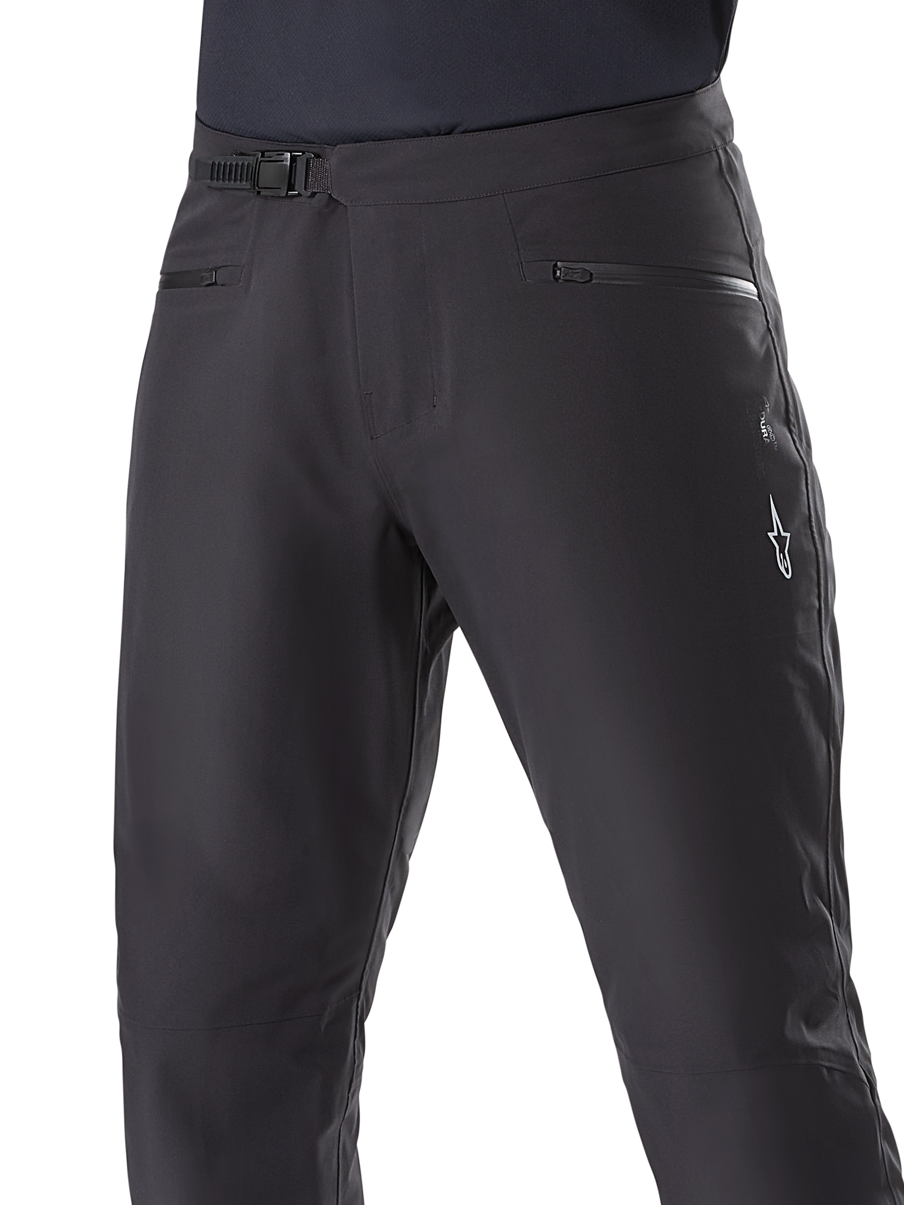 Alpinestars A-Dura Waterproof Pants, pantalon de VTT, noir, gros plan de la taille montrant le système de fermeture à cliquet et les poches zippées, logo Alpinestars blanc sur la cuisse, textile durable pour la pratique du VTT par temps humide