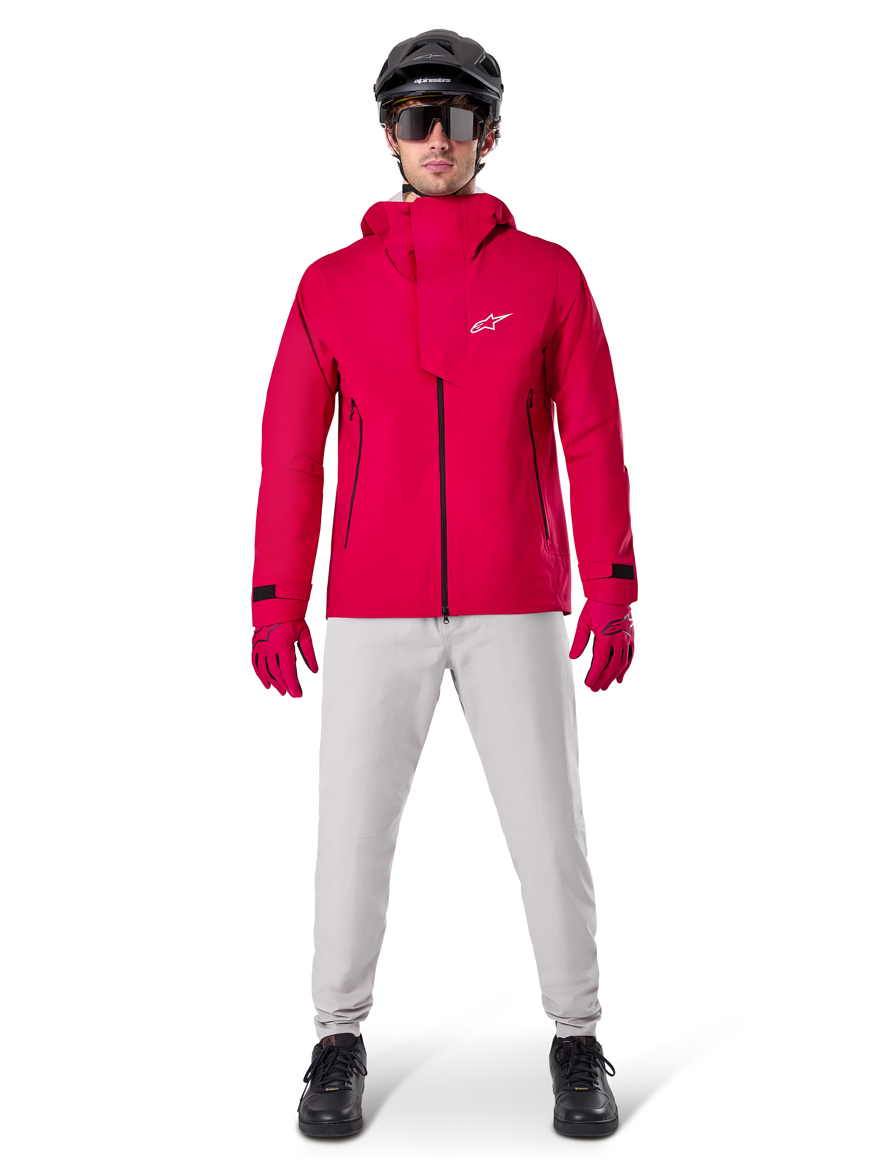 Pantalon imperméable Alpinestars A-Dura, pantalon de VTT, gris titane, porté avec une veste à capuche rouge vif, des gants rouges et un casque de VTT noir, équipement de cyclisme imperméable professionnel pour conditions de sentiers humides