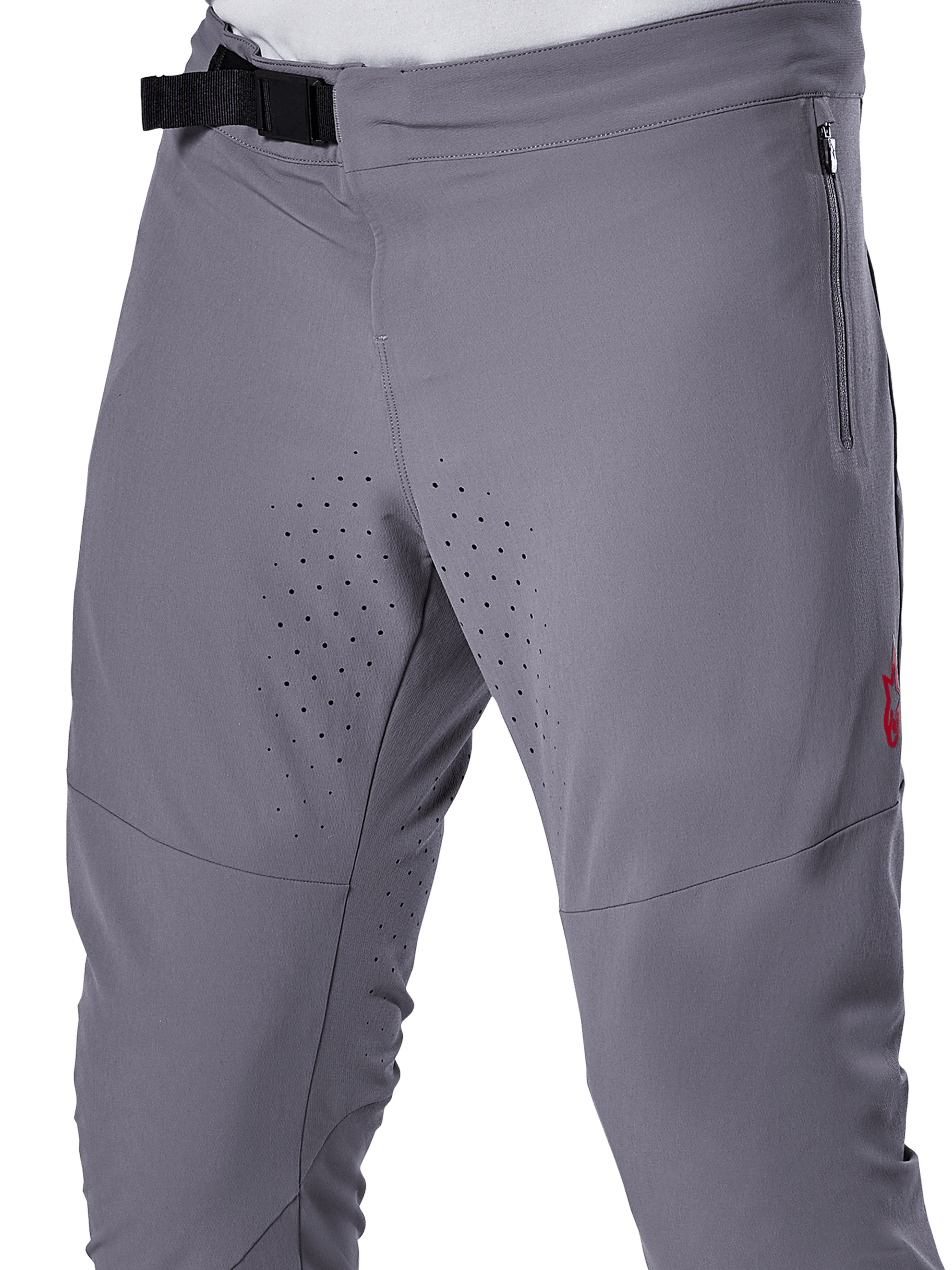 Pantalon Alpinestars A-Aria Elite, pantalon de VTT, gris foncé, vue rapprochée présentant la fermeture à boucle magnétique, la poche latérale zippée et les perforations de ventilation laser sur l'intérieur des cuisses pour la performance en trail.