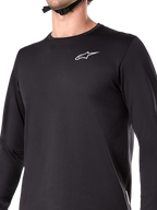 Maillot thermique Alpinestars A-Dura, maillot de cyclisme à manches longues, noir, avec logo blanc sur la poitrine, tissu doublé de polaire isolante, pan arrière allongé, conçu pour le VTT par temps froid