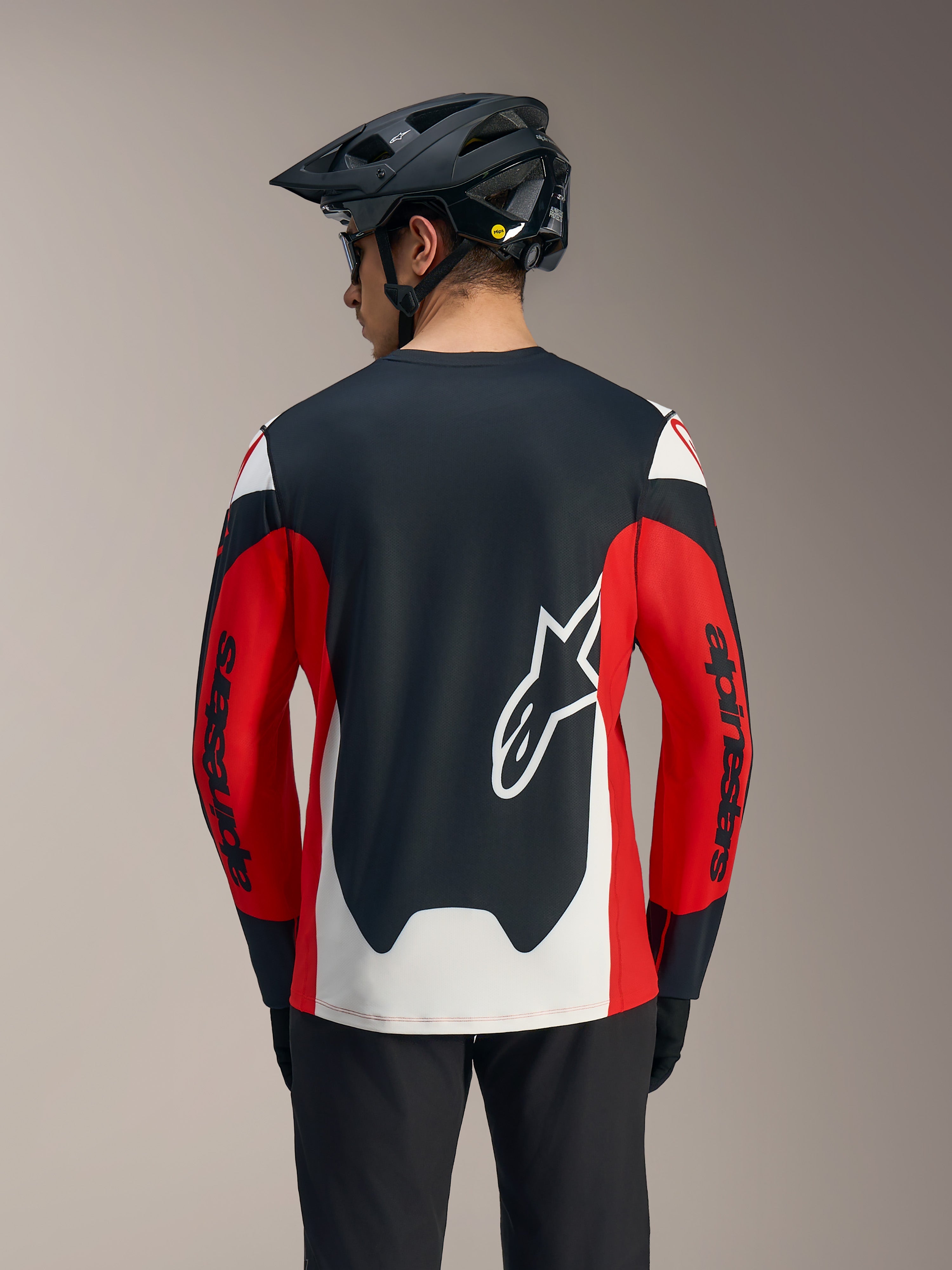 A-Dura Race Jersey met lange mouwen in rood, zwart en wit, met groot wit Astars-logo en racing graphics op de rug.