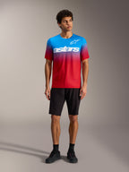 A-Dura ASTARS Jersey 2.0 in Bright Red Blue gradient with white chest logo, paired with black MTB shorts and shoes.