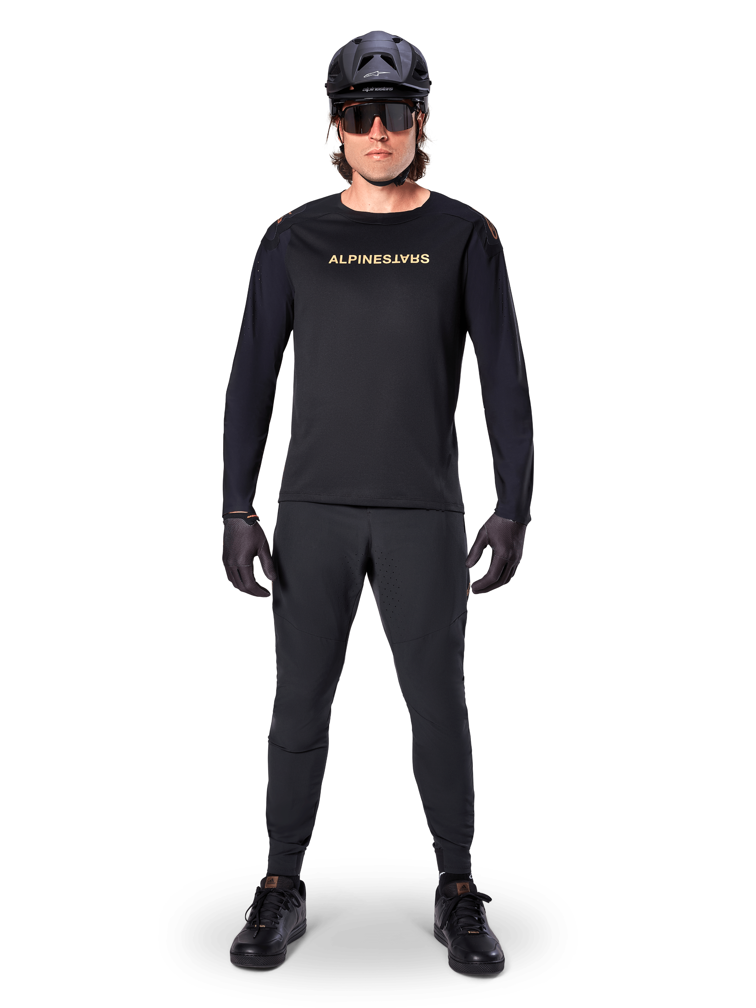 Alpinestars A-Aria Polartec Switch Long Sleeve Jersey, Black, worn by a rider with matching black technical pants, black helmet, sunglasses, and black gloves, performance MTB gear for off-road trails