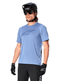 Alpinestars A-Dura Dri Astar Jersey Short Sleeve, Infinity Blue, mountain bike jersey with mesh sleeve ventilation and a large chest logo, worn with black helmet, sunglasses, and gloves, technical MTB performance apparel