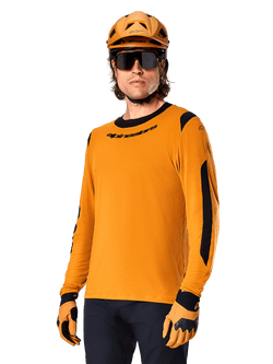 Alpinestars A-Dura Dri Wool Jersey - Long Sleeve, MTB Mountain Biking Jersey, Dark Gold and Black, featuring moisture-wicking merino wool blend and mesh panels, rider wearing matching helmet, sunglasses, and gloves