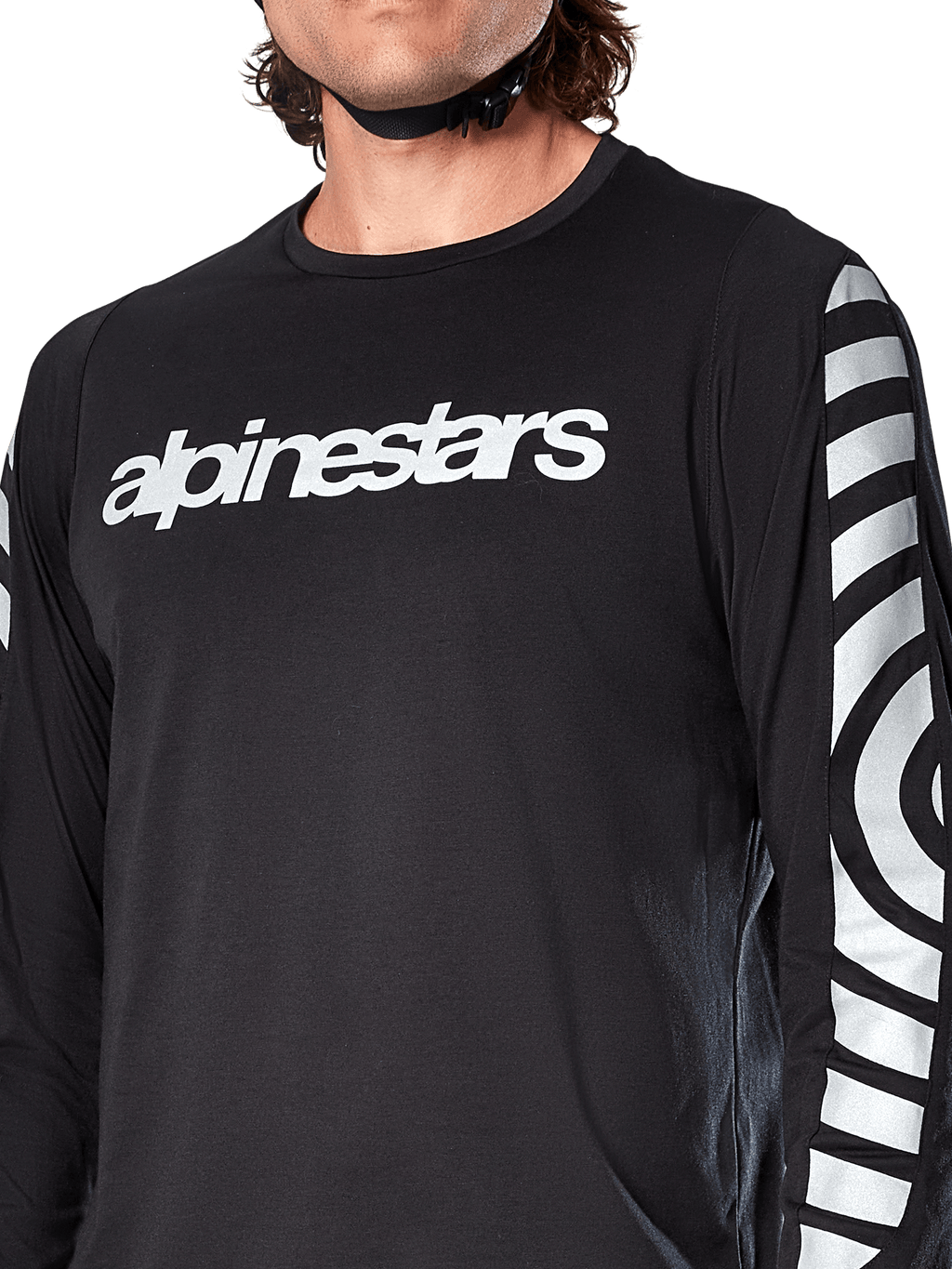 Alpinestars A-Dura Dri Oscar Long Sleeve Jersey, Black Reflective, close-up view showing white alpinestars logo on the chest and reflective circular graphics on the sleeves, technical cycling apparel for mountain biking