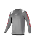 Alpinestars Youth A Supra Astar Long Sleeve Jersey, jeugd mountainbike shirt met lange mouwen, donkergrijs met witte schouderaccenten en rode branding op de mouwen, wit logo op de borst, ademend technisch materiaal, ronde halslijn, atletische pasvorm voor mountainbiken